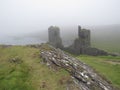 Picturesque view of Dunlough Castle in West Cork, Ireland on a foggy day Royalty Free Stock Photo