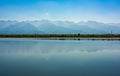 Picturesque view of the Fagaras mountain range mirrored in water of artificial lake, Transylvania, Romania