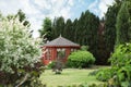 Picturesque view of gazebo in beautiful garden on sunny day Royalty Free Stock Photo