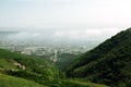 Picturesque view of Gelendzhik: the mountains covered with forests surround a small town with tiled houses on the Black Sea coas