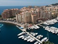 boats docked in harbor with large buildings and apartment complexes on edge Royalty Free Stock Photo