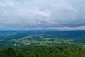 A picturesque view from a height of green fields and forests on a cloudy day. Royalty Free Stock Photo
