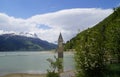 scenic view of lake Resia and sunken church steeple of Lago di Resia in Curon region (Vinschgau, South Tyrol, Italy) Royalty Free Stock Photo