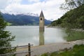 scenic view of lake Resia and sunken church steeple of Lago di Resia in Curon region (Vinschgau, South Tyrol, Italy) Royalty Free Stock Photo