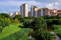 Picturesque view of local colourful public housing in setting of lush greenery, on bright sunny day