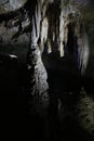 Picturesque view of many stalactite and stalagmite formations in dark cave