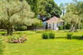 Picturesque view of the Mediterranean landscape with a beautiful lawn, a small farmhouse and olive and cypress trees Royalty Free Stock Photo