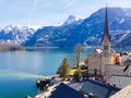 Picturesque view of the mountains, lake, blue sky and Hallstatt village. View at the church.