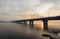 Picturesque view over the Paton`s Bridge over the Dnieper River during winter sunrise. Sun reflected in the water. Kyiv, Ukraine Royalty Free Stock Photo