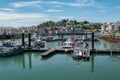 Port of Saint Jean de Luz with some boats anchored with part of the city in the background Royalty Free Stock Photo