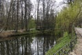 Picturesque view of  pond with bridge and reflections in water in green spring park Royalty Free Stock Photo