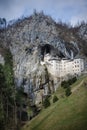 Picturesque view of the Predjama Castle situated in the middle of a towering cliff in Slovenia