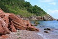 A Picturesque view of the rocky & pebbled beach at Oddicombe in Devon