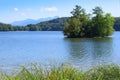 Picturesque view of small lake with wooded islet