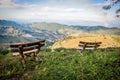 Picturesque view to Doi Mae Salong valley with tea plantations with wooden benches on foreground