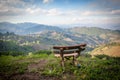 Picturesque view to Doi Mae Salong valley with tea plantations with wooden benches on foreground