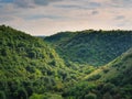 Picturesque view to the green forest on the hills. Idyllic summer landscape scene. Environment and nature conservation concept. Royalty Free Stock Photo