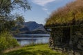 Picturesque view to a Norwegian mountain lake with an old stone building