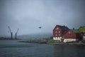 SkansapakkhusiÃÂ° at the tip of Tinganes peninsula and Torshavn Port cranes over the Eystara VÃÂ¡g.