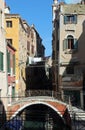 Picturesque view of Venice Italy showing a bridge laundry hanging out and a navigable canal between houses