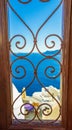 Vintage window with view in picturesque Oia Santorini island and Caldera