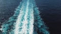 Picturesque view of the wake behind a large cruise ship at sea. Stock. Sailing cruise ship track with calm sea and clear Royalty Free Stock Photo