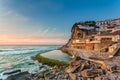 Picturesque village Azenhas do Mar. Holiday white houses on the edge of a cliff with a beach and swimming pool below. Landmark nea Royalty Free Stock Photo