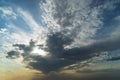 Picturesque white clouds illuminated by sunlight at sunset