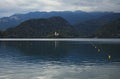 Picturesque wide-angle landscape view of Bled Lake. The most famous lake in Slovenia. Cloudy weather Royalty Free Stock Photo