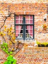Picturesque window of an old brick house, Bruges, Belgium