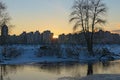 Picturesque winter landscape of frozen Dnieper River during sunset. Buildings of The Obolon neighborhood in the background Royalty Free Stock Photo