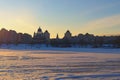 Picturesque winter landscape of frozen Dnieper River during sunset. Buildings of The Obolon neighborhood in the background. Royalty Free Stock Photo