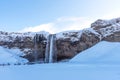 Picturesque winter landscape view of frozen beautiful waterfall Seljalandsfoss in Iceland Royalty Free Stock Photo