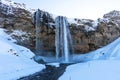 Picturesque winter landscape view of frozen beautiful waterfall Seljalandsfoss in Iceland Royalty Free Stock Photo