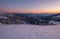 Picturesque winter morning pre sunrise alps. View of famous Ukrainian Dragobrat ski resort from Svydovets mountain ridge