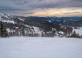 Picturesque winter windy and cloudy morning alps. View of famous Ukrainian Dragobrat ski resort from Svydovets mountain ridge