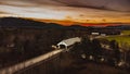 a covered bridge going over a rural road in the country Royalty Free Stock Photo