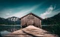 Picturesque wooden fishing shack situated on a dock overlooking a serene lake in Chiemsee, Germany Royalty Free Stock Photo