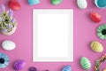 Picure frame mockup on pink desk. Easter decorations beside Royalty Free Stock Photo