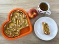 Pie with almonds and apricots with one sliced piece on a plate and apple and tea in a cup Royalty Free Stock Photo