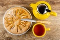 Pie with apples charlotte, knife, yellow teapot, cup with tea on table. Top view Royalty Free Stock Photo