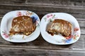 A pie baked dough covered with chocolate sauce and stuffed with pieces of chocolate, biscuit pieces, banana, cake, caramel and Royalty Free Stock Photo