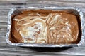 A pie baked dough covered with chocolate sauce and stuffed with pieces of chocolate, biscuit pieces, banana, cake, caramel and Royalty Free Stock Photo