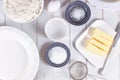 Pie crust ingredients in bowls. Flour, sugar, salt, ice water, butter and egg