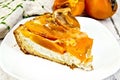 Pie with curd and persimmons in plate on board Royalty Free Stock Photo