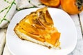 Pie with curd and persimmons in plate Royalty Free Stock Photo