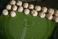 Pie dough balls on a rolling mat. Royalty Free Stock Photo