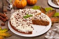 Pie with pumpkin and walnuts, covered with cream cheese and chopped chocolate