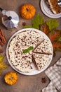 Pie with pumpkin and walnuts, covered with cream cheese and chopped chocolate. Top view