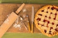 Pie with rolling pin on wooden surface